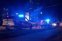Parked police cars with emergency lights activated on Scott Road