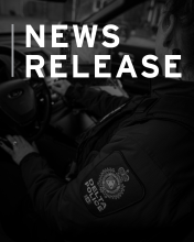 DPD News release template - officer seated in police car