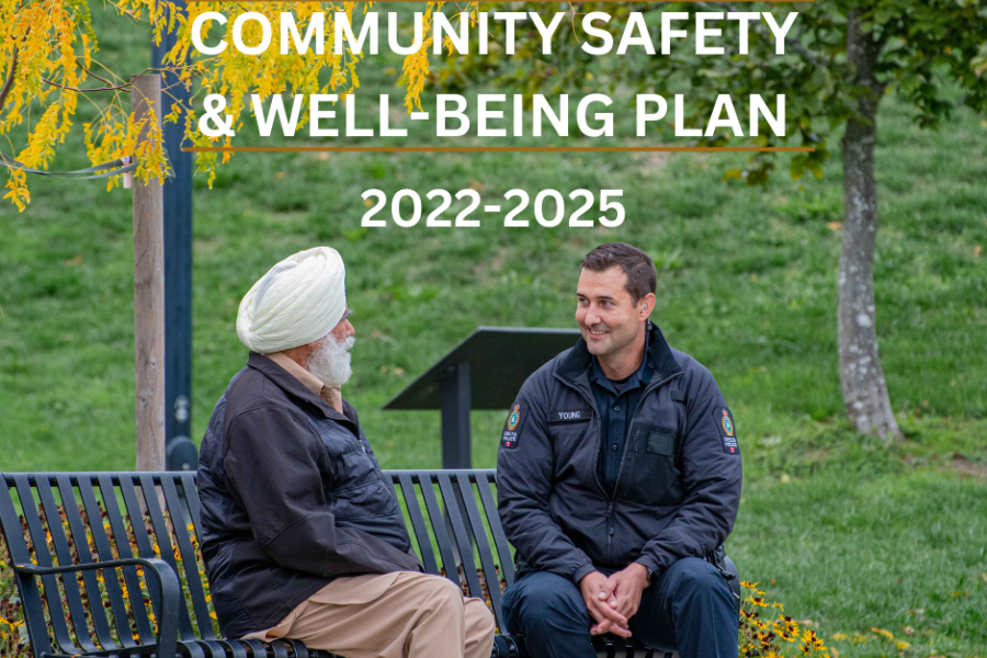 Photo of a Delta Police officer sitting and talking with a member of our community